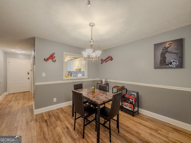 2610 Cumberland Ct, Smyrna, GA 30080 - dining room with a textured ceiling, a chandelier, wood finished floors, and baseboards