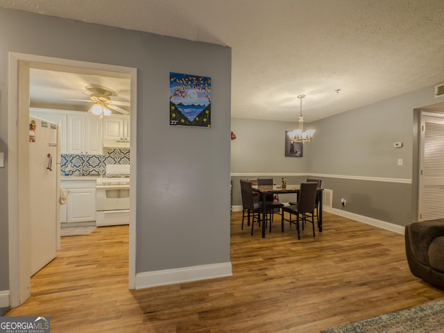 2610 Cumberland Ct, Smyrna, GA 30080 - dining room with light wood-style flooring, a chandelier, baseboards, and a textured ceiling