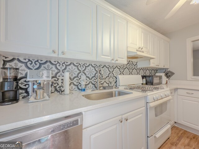 2610 Cumberland Ct, Smyrna, GA 30080 - kitchen with white range with gas cooktop, dishwasher, under cabinet range hood, a sink, and light countertops