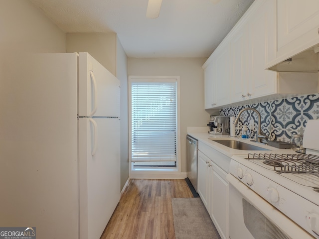 2610 Cumberland Ct, Smyrna, GA 30080 - kitchen featuring white appliances, a sink, tasteful backsplash, white cabinets, and light wood-style flooring