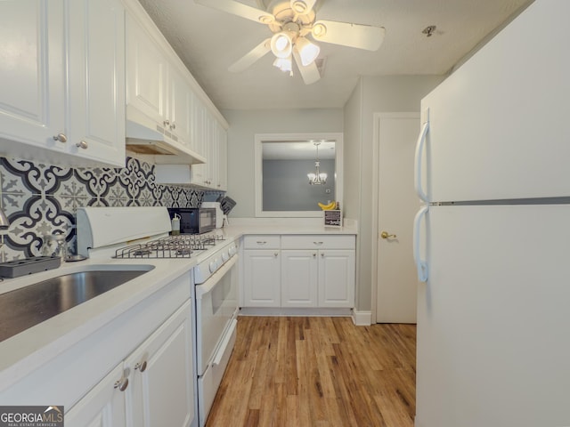 2610 Cumberland Ct, Smyrna, GA 30080 - kitchen featuring white appliances, under cabinet range hood, white cabinets, and light wood finished floors