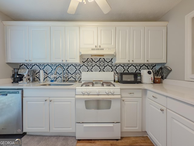 2610 Cumberland Ct, Smyrna, GA 30080 - kitchen featuring dishwasher, under cabinet range hood, white gas stove, a sink, and black microwave