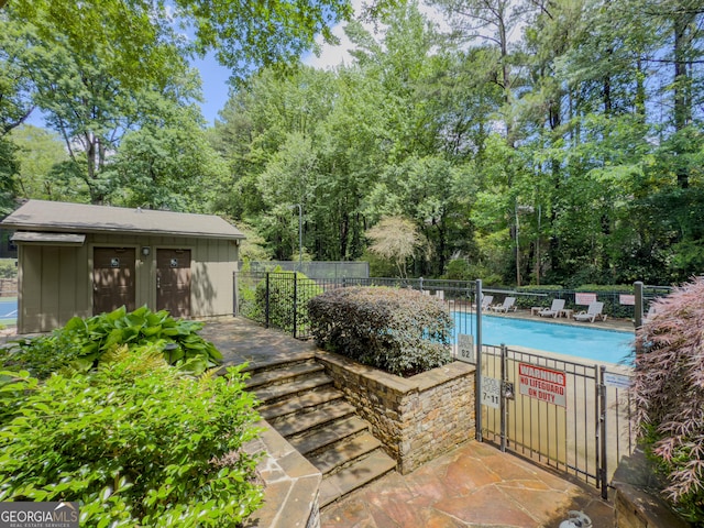 2610 Cumberland Ct, Smyrna, GA 30080 - community pool with fence, a patio area, and view of scattered trees
