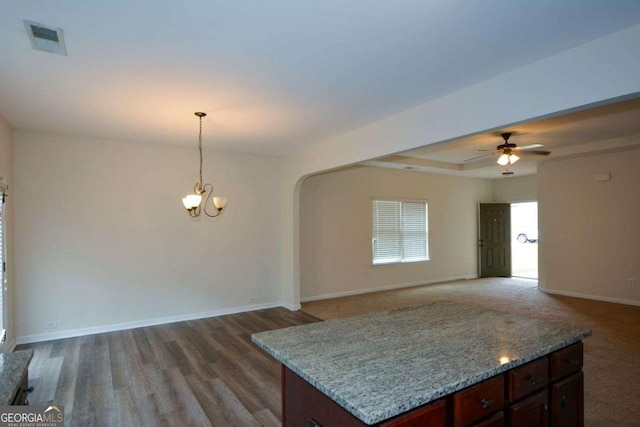 kitchen with a ceiling fan, baseboards, a chandelier, pendant lighting, and arched walkways