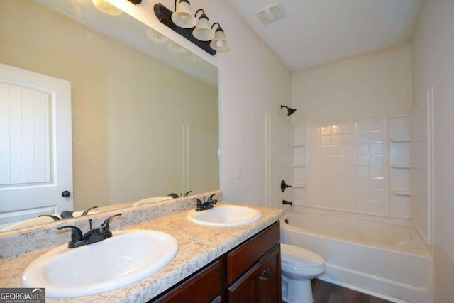 full bath with toilet, double vanity, and  shower combination