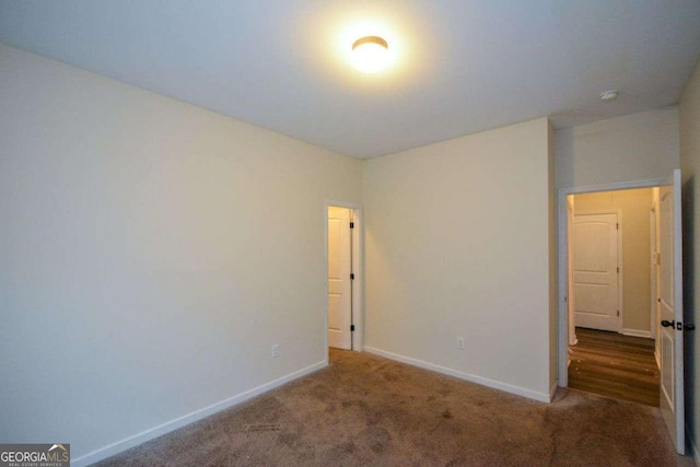 unfurnished bedroom featuring carpet flooring and baseboards