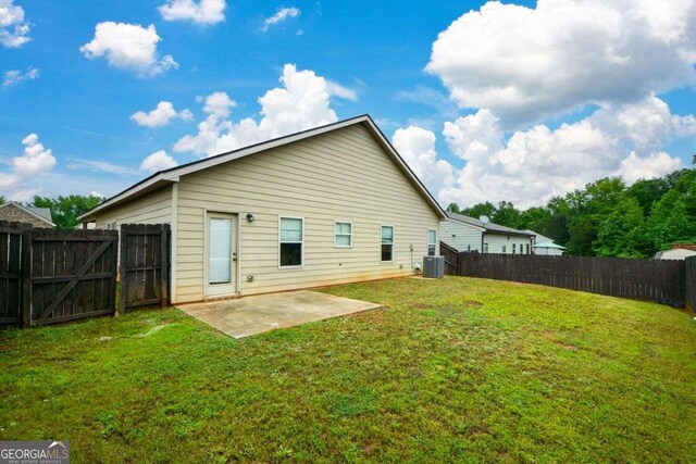 rear view of house with central air condition unit and a patio