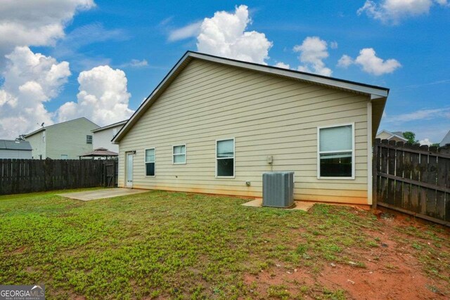 back of property featuring central AC and a patio area