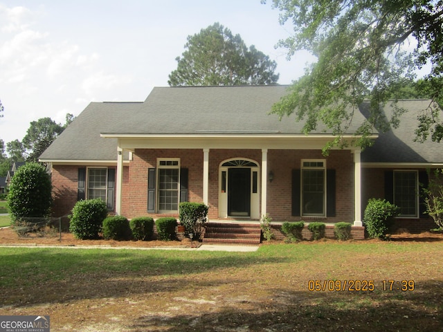 1009 Hunters Pointe Dr, Statesboro, GA 30461 - view of front of home with brick siding, covered porch, and a front lawn