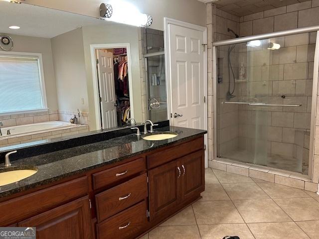 1009 Hunters Pointe Dr, Statesboro, GA 30461 - full bathroom featuring tile patterned floors, a stall shower, double vanity, and a walk in closet