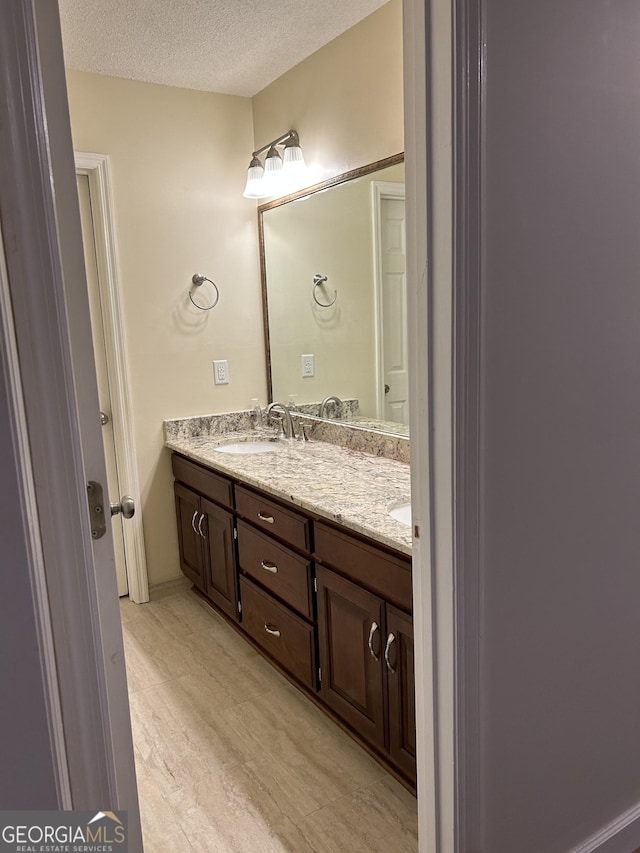 1009 Hunters Pointe Dr, Statesboro, GA 30461 - bathroom featuring double vanity and a textured ceiling