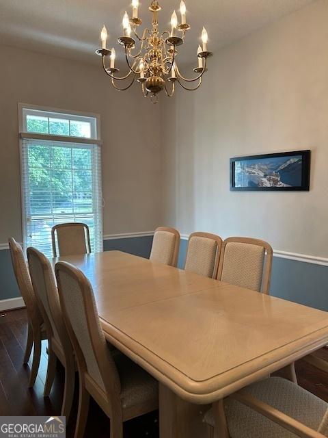 1009 Hunters Pointe Dr, Statesboro, GA 30461 - dining space with a chandelier, dark wood-style flooring, and baseboards