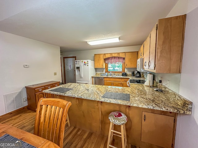 30 Putter Ln, Dillard, GA 30537 - kitchen with white appliances, a peninsula, light wood-style flooring, and light stone countertops