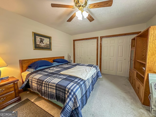 30 Putter Ln, Dillard, GA 30537 - bedroom featuring two closets, light colored carpet, a textured ceiling, and a ceiling fan
