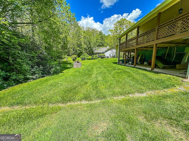 30 Putter Ln, Dillard, GA 30537 - view of grassy yard with a wooden deck and a patio