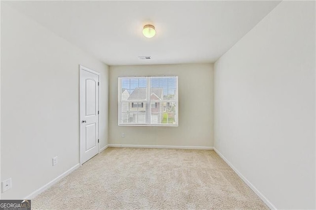 unfurnished room with carpet flooring and baseboards