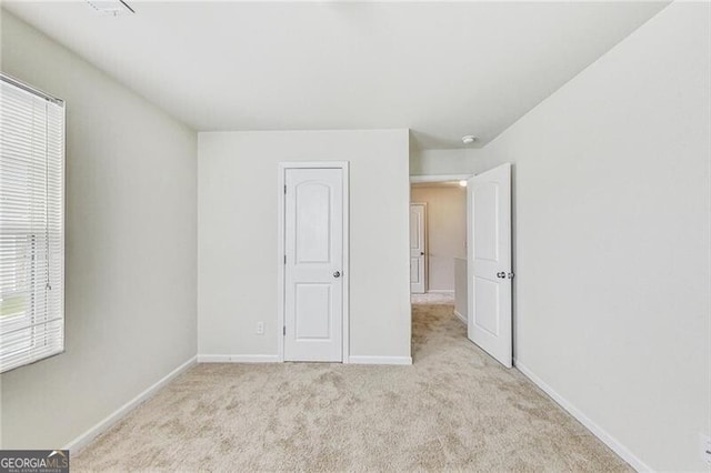unfurnished bedroom with carpet and baseboards