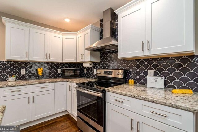 3224 Canary Ct, Decatur, GA 30032 - kitchen with stainless steel range with electric stovetop, wall chimney exhaust hood, white cabinets, decorative backsplash, and dark wood-style floors