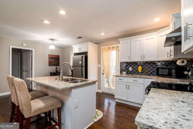 3224 Canary Ct, Decatur, GA 30032 - kitchen with black appliances, extractor fan, dark wood-style floors, decorative backsplash, and recessed lighting