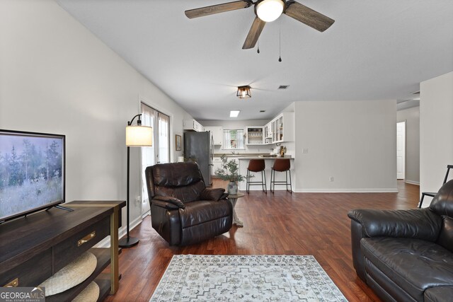 142 Dawn Cir, Brunswick, GA 31523 - living area featuring dark wood-style floors, ceiling fan, and baseboards