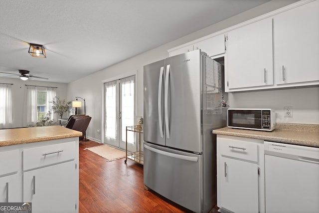 142 Dawn Cir, Brunswick, GA 31523 - kitchen featuring freestanding refrigerator, white dishwasher, dark wood finished floors, white cabinets, and light countertops
