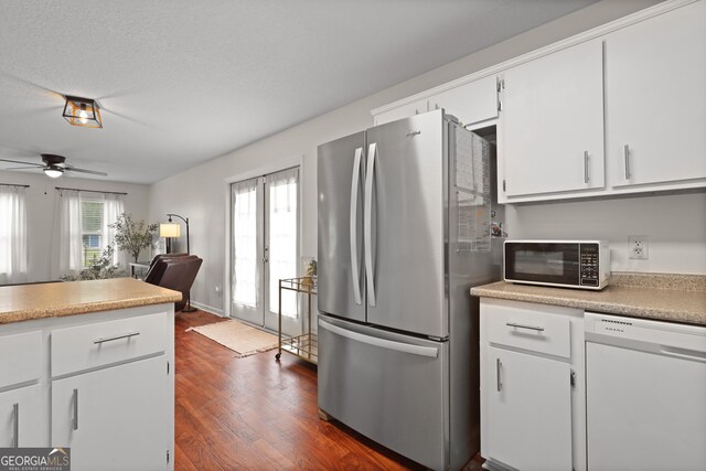 142 Dawn Cir, Brunswick, GA 31523 - kitchen featuring freestanding refrigerator, dishwasher, black microwave, dark wood-style floors, and white cabinets
