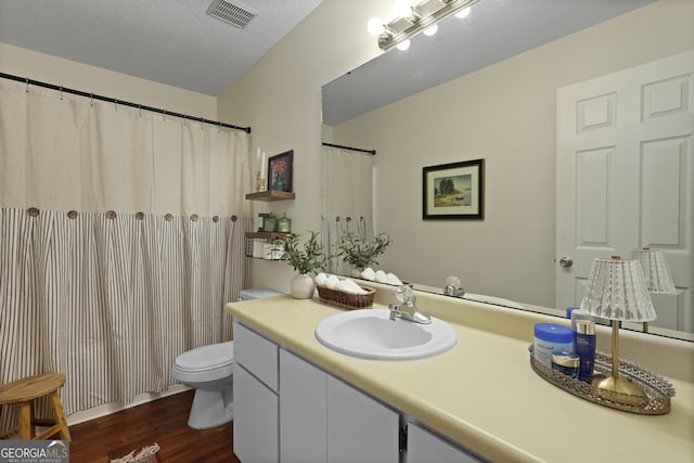 142 Dawn Cir, Brunswick, GA 31523 - bathroom featuring wood finished floors, toilet, and vanity
