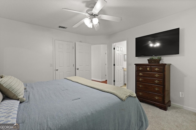 142 Dawn Cir, Brunswick, GA 31523 - bedroom with light colored carpet, baseboards, a ceiling fan, and connected bathroom