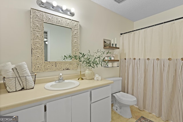 142 Dawn Cir, Brunswick, GA 31523 - full bath with toilet, vanity, tile patterned floors, and a textured ceiling