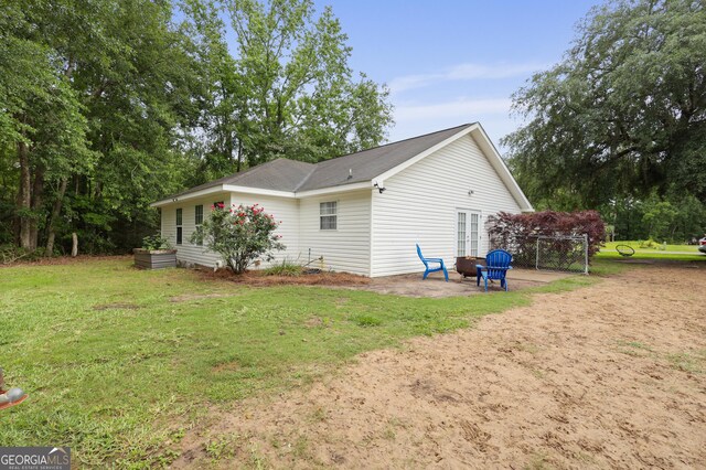 142 Dawn Cir, Brunswick, GA 31523 - view of property exterior with a patio and a lawn