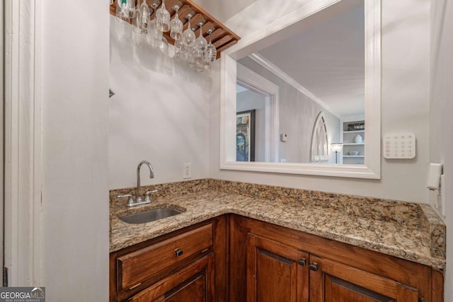 bathroom featuring vanity and ornamental molding