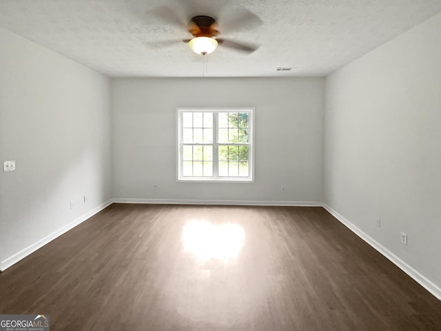 5480 Walnut Ln, Lithonia, GA 30038 - unfurnished room featuring dark wood finished floors, ceiling fan, and a textured ceiling