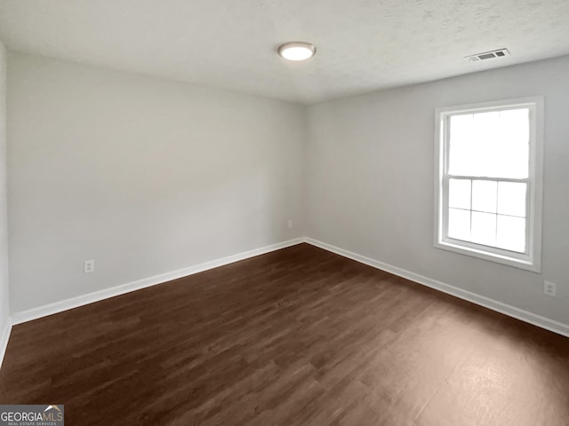 5480 Walnut Ln, Lithonia, GA 30038 - unfurnished room featuring baseboards and dark wood-style floors
