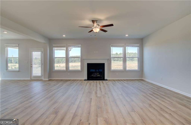 612 Sidney Ct, Stockbridge, GA 30281 - unfurnished living room featuring ceiling fan, light wood-type flooring, plenty of natural light, baseboards, and recessed lighting