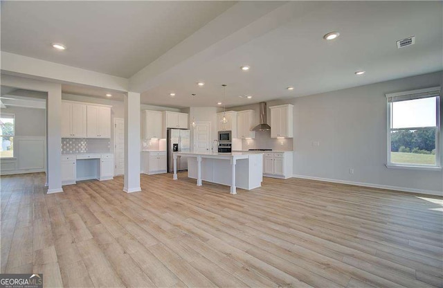 612 Sidney Ct, Stockbridge, GA 30281 - unfurnished living room with light wood-style flooring, baseboards, and recessed lighting