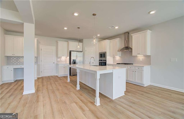 612 Sidney Ct, Stockbridge, GA 30281 - kitchen with stainless steel appliances, wall chimney range hood, tasteful backsplash, a sink, and white cabinets
