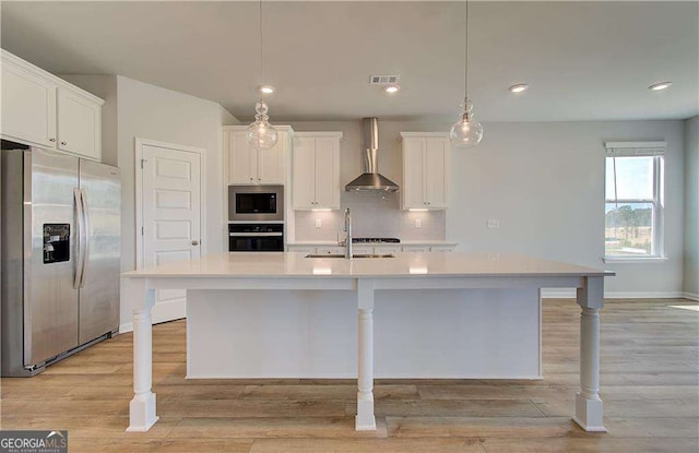 612 Sidney Ct, Stockbridge, GA 30281 - kitchen with appliances with stainless steel finishes, wall chimney range hood, a sink, light countertops, and recessed lighting