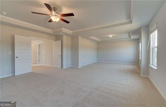 612 Sidney Ct, Stockbridge, GA 30281 - spare room with a tray ceiling, ceiling fan, light colored carpet, ornamental molding, and baseboards