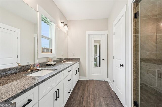 166 Wagon Trail Cir, Fairmount, GA 30139 - full bathroom with double vanity, wood finished floors, and a tile shower
