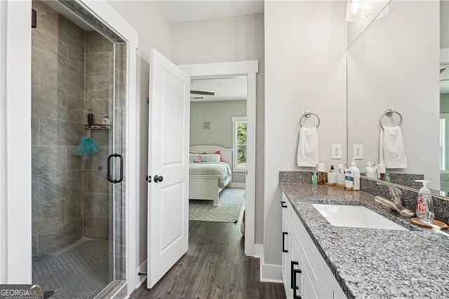 166 Wagon Trail Cir, Fairmount, GA 30139 - bathroom with wood finished floors, vanity, a stall shower, and connected bathroom
