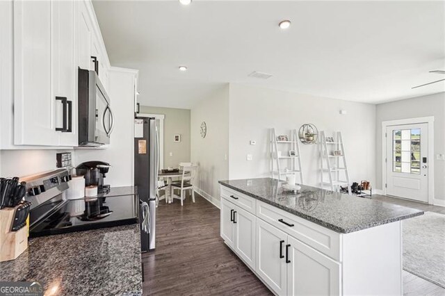 166 Wagon Trail Cir, Fairmount, GA 30139 - kitchen featuring appliances with stainless steel finishes, a kitchen island, white cabinetry, dark stone countertops, and recessed lighting