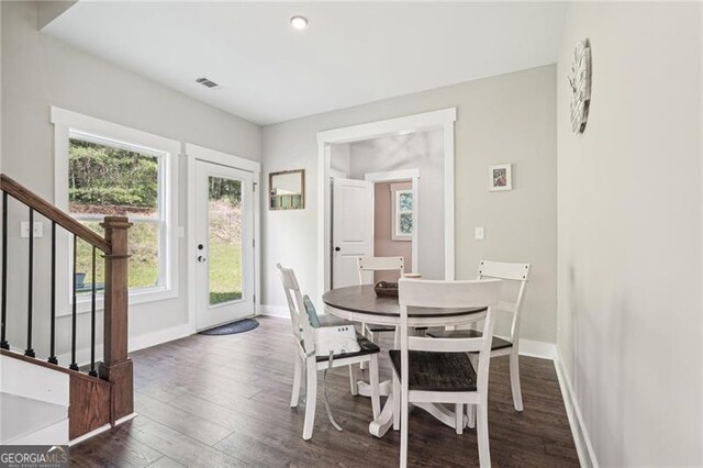 166 Wagon Trail Cir, Fairmount, GA 30139 - dining area featuring healthy amount of natural light, stairs, dark wood-type flooring, and recessed lighting