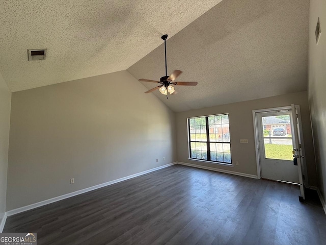 1397 Coalition Cir, Hinesville, GA 31313 - unfurnished living room with a ceiling fan, a textured ceiling, dark wood finished floors, baseboards, and high vaulted ceiling