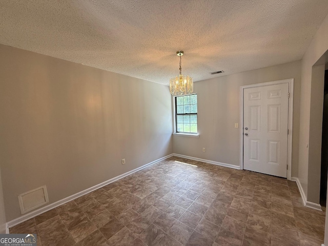 1397 Coalition Cir, Hinesville, GA 31313 - unfurnished dining area featuring a chandelier, a textured ceiling, and baseboards