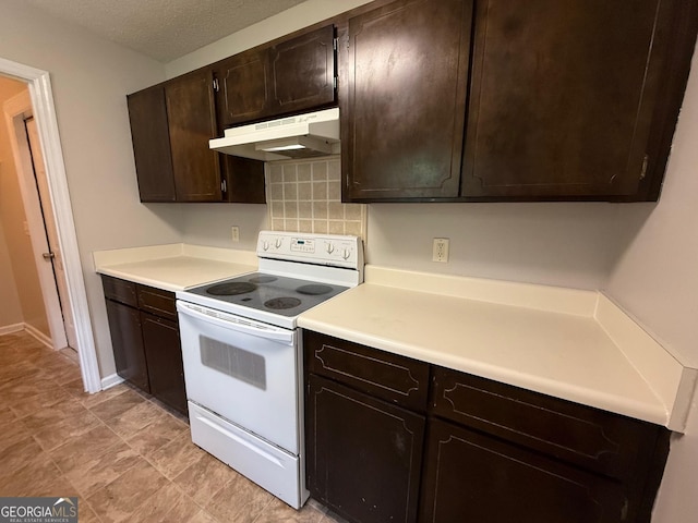 1397 Coalition Cir, Hinesville, GA 31313 - kitchen featuring white range with electric stovetop, under cabinet range hood, dark brown cabinetry, light countertops, and a textured ceiling