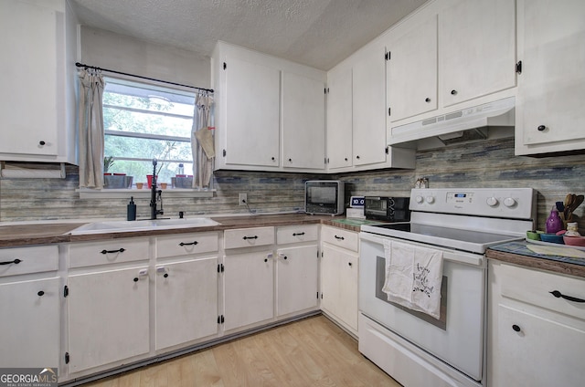 7 Valley View Dr, Cartersville, GA 30120 - kitchen with white electric range, under cabinet range hood, a textured ceiling, tasteful backsplash, and white cabinetry