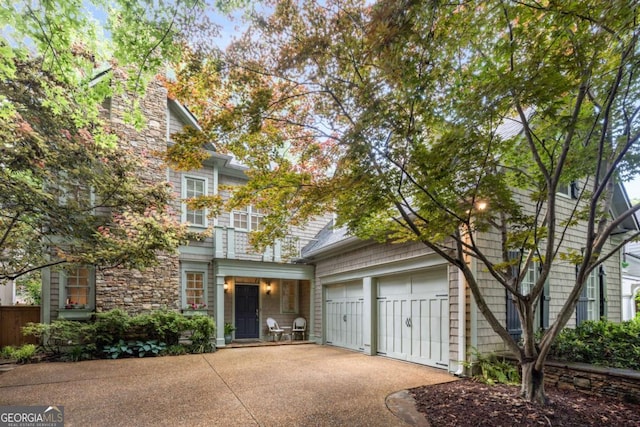 626 Kimberly Ln NE, Atlanta, GA 30306 - view of front of house featuring concrete driveway, stone siding, and a garage