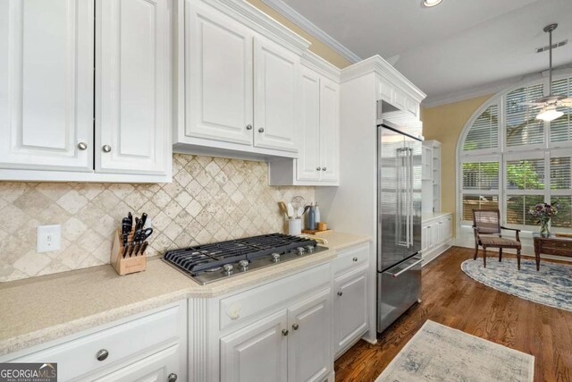 626 Kimberly Ln NE, Atlanta, GA 30306 - kitchen with appliances with stainless steel finishes, white cabinetry, light countertops, backsplash, and dark wood-type flooring