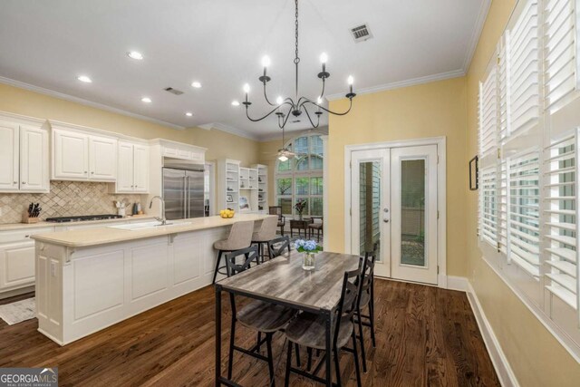 626 Kimberly Ln NE, Atlanta, GA 30306 - dining room with french doors, crown molding, dark wood finished floors, a chandelier, and recessed lighting