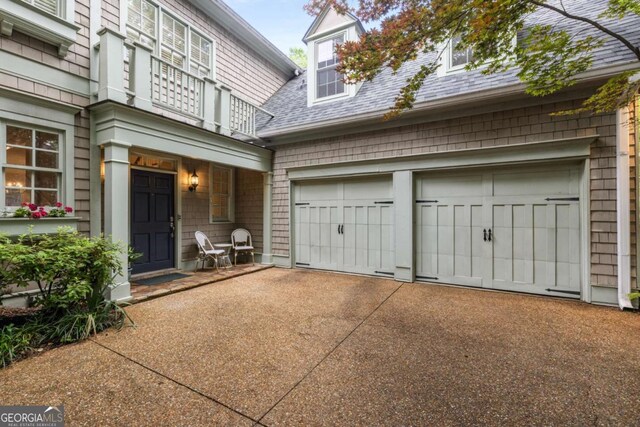626 Kimberly Ln NE, Atlanta, GA 30306 - view of exterior entry featuring roof with shingles and concrete driveway